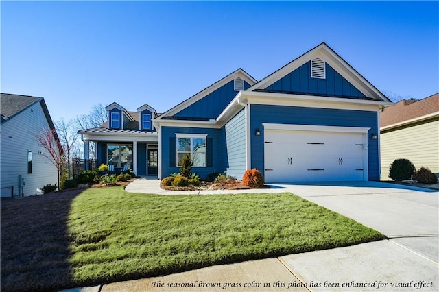 view of front of property featuring a garage and a front lawn