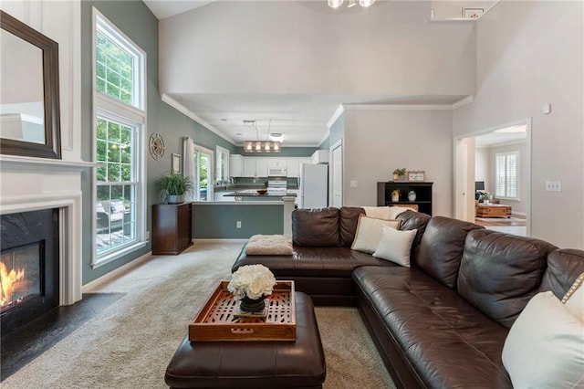 475 Chippenham Ct, Alpharetta, GA 30005 - living room with ornamental molding, a high ceiling, a high end fireplace, and light colored carpet