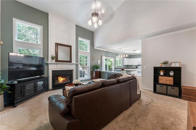 475 Chippenham Ct, Alpharetta, GA 30005 - living room with a chandelier, a large fireplace, light carpet, lofted ceiling, and crown molding