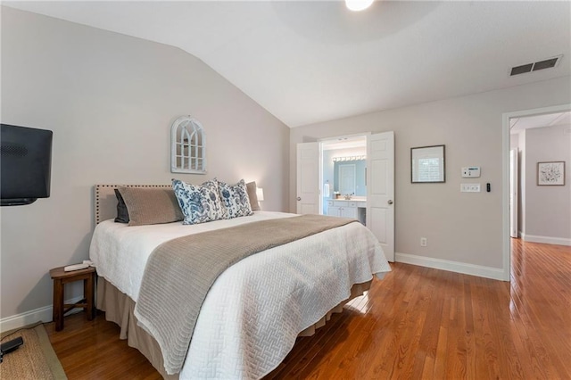475 Chippenham Ct, Alpharetta, GA 30005 - bedroom featuring vaulted ceiling, wood finished floors, and ensuite bath