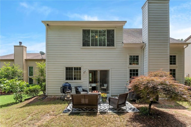 475 Chippenham Ct, Alpharetta, GA 30005 - back of house with an outdoor living space, a chimney, a lawn, a patio area, and a shingled roof