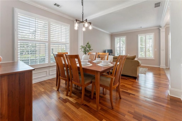 475 Chippenham Ct, Alpharetta, GA 30005 - dining room with crown molding, wood finished floors, and a chandelier