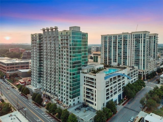 property at dusk featuring a city view