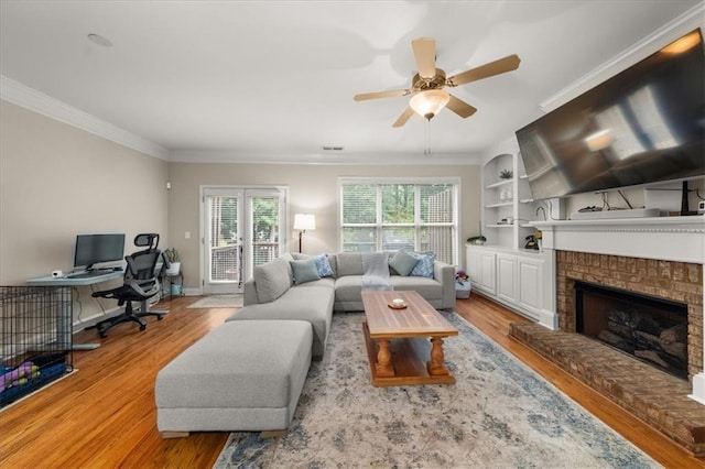 3937 Covey Flush Ct SW Unit 25, Smyrna, GA 30082 - living area featuring wood finished floors, an office area, ornamental molding, ceiling fan, and a fireplace