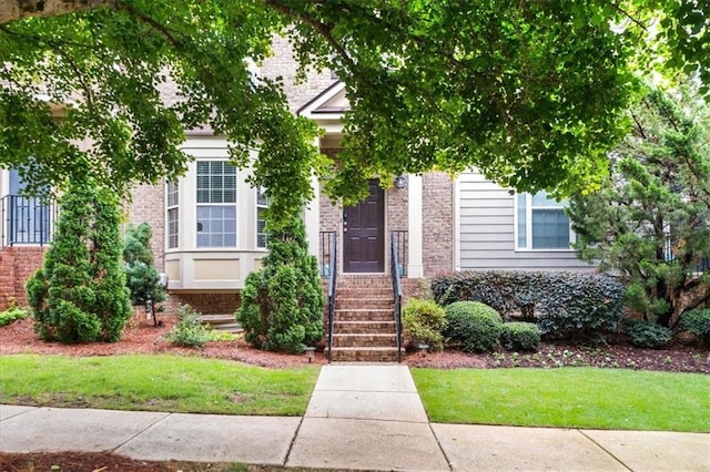 3937 Covey Flush Ct SW Unit 25, Smyrna, GA 30082 - obstructed view of property with brick siding and a front yard