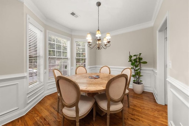 3937 Covey Flush Ct SW Unit 25, Smyrna, GA 30082 - dining area with a chandelier, wainscoting, wood finished floors, a decorative wall, and crown molding