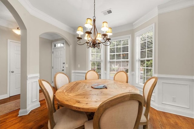3937 Covey Flush Ct SW Unit 25, Smyrna, GA 30082 - dining space featuring arched walkways, a chandelier, ornamental molding, wood finished floors, and wainscoting