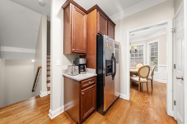 3937 Covey Flush Ct SW Unit 25, Smyrna, GA 30082 - kitchen with stainless steel fridge with ice dispenser, ornamental molding, light wood-style flooring, light stone counters, and brown cabinets