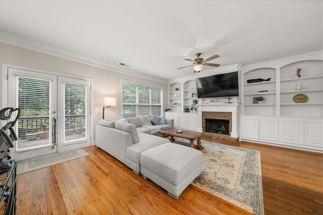 3937 Covey Flush Ct SW Unit 25, Smyrna, GA 30082 - living area with a fireplace, crown molding, ceiling fan, light wood-style floors, and french doors