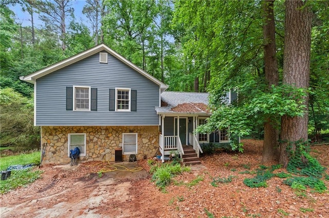 4585 Muirwood Cir, Powder Springs, GA 30127 - tri-level home with roof with shingles and covered porch
