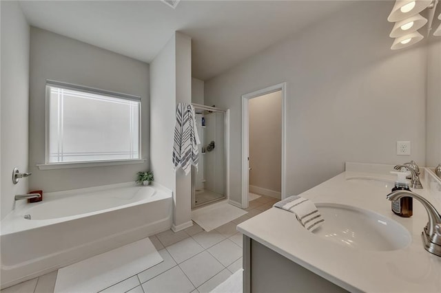 bathroom with a garden tub, tile patterned flooring, a sink, and a shower stall