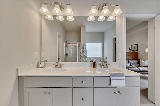 ensuite bathroom featuring ensuite bathroom, double vanity, a sink, and a shower stall