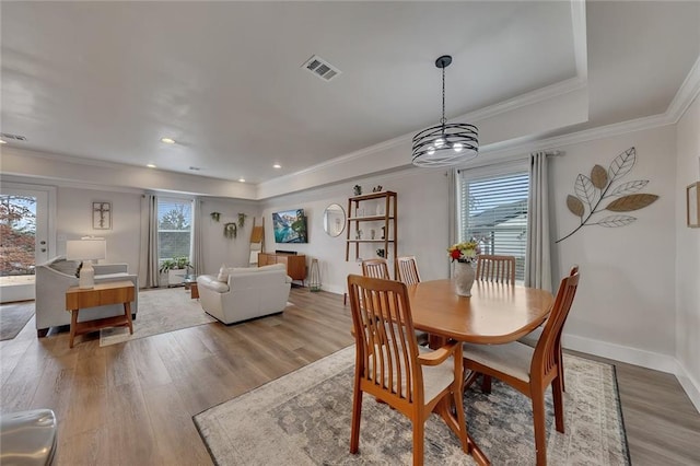 dining area with a wealth of natural light, light wood-type flooring, and visible vents