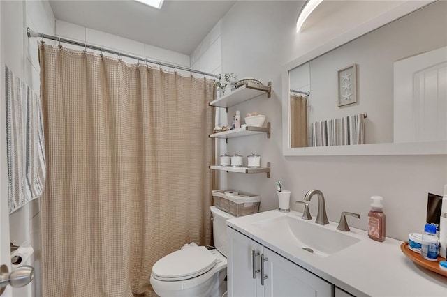 bathroom featuring vanity, toilet, and a shower with curtain