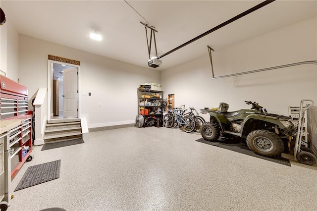 garage with baseboards and a garage door opener