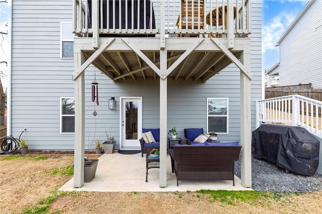 rear view of property featuring fence, an outdoor hangout area, and a patio