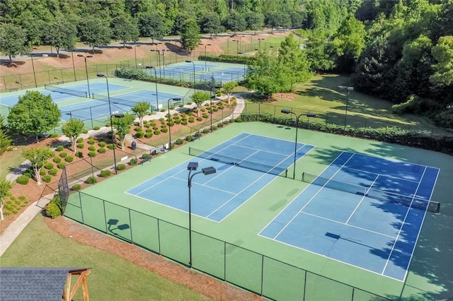 view of tennis court featuring fence