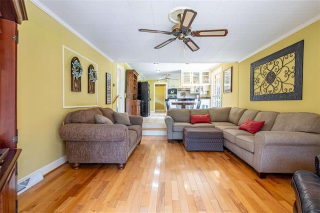 268 Tuck St, Cedartown, GA 30125 - living room featuring ornamental molding, ceiling fan, light wood-style flooring, and baseboards