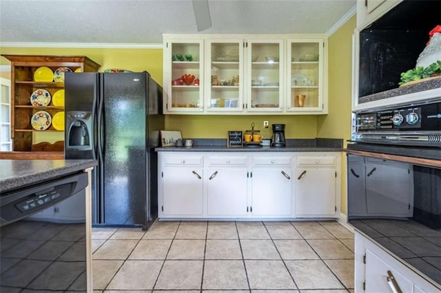 268 Tuck St, Cedartown, GA 30125 - kitchen with black appliances, dark countertops, a textured ceiling, light tile patterned floors, and glass insert cabinets
