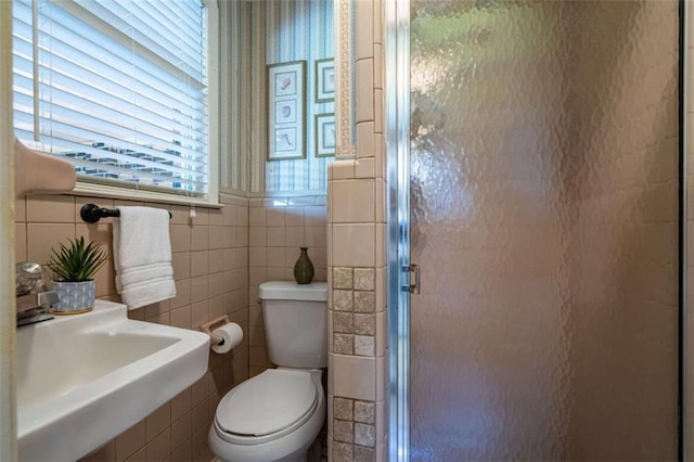 268 Tuck St, Cedartown, GA 30125 - bathroom featuring tile walls, a shower stall, toilet, and a sink