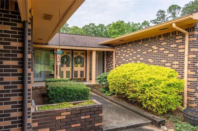 268 Tuck St, Cedartown, GA 30125 - doorway to property featuring brick siding and a shingled roof
