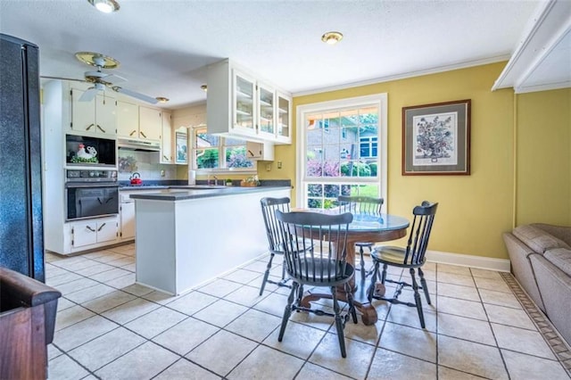 268 Tuck St, Cedartown, GA 30125 - dining room with a ceiling fan, light tile patterned flooring, crown molding, baseboards, and a textured ceiling