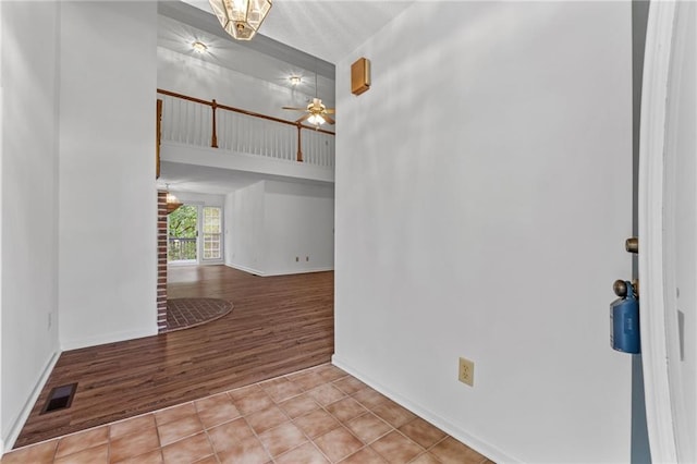 spare room with ceiling fan and light tile patterned flooring