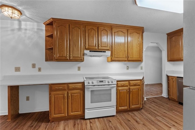 kitchen featuring electric range, light wood-type flooring, stainless steel dishwasher, and a textured ceiling