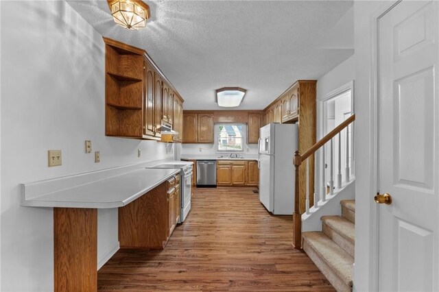 kitchen featuring white appliances and light hardwood / wood-style flooring