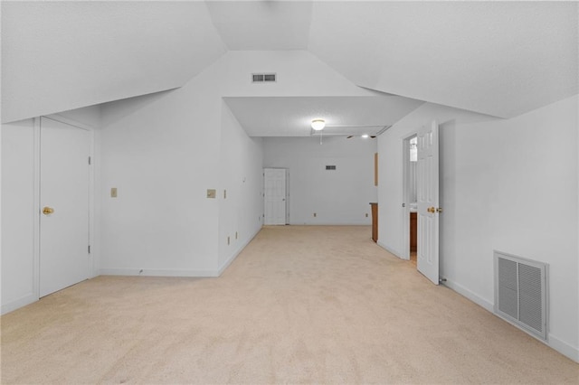 unfurnished room with lofted ceiling and light colored carpet