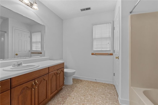 bathroom featuring toilet and vanity