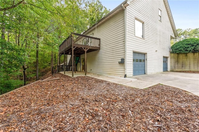 rear view of house with a deck and a garage