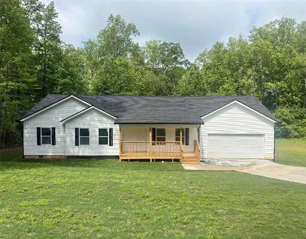191 Deerfield Ln, Carrollton, GA 30116 - view of front of house featuring covered porch, an attached garage, concrete driveway, and a front lawn