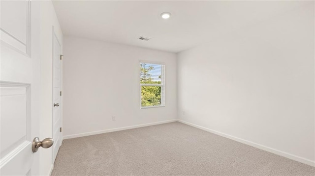 unfurnished room with light colored carpet, baseboards, and recessed lighting