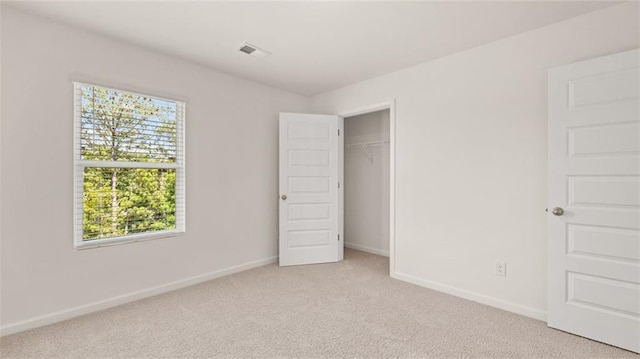 unfurnished bedroom featuring light colored carpet and baseboards