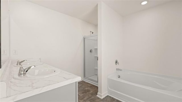 full bath featuring a shower stall, a bath, and double vanity
