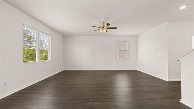 empty room with a ceiling fan, dark wood finished floors, baseboards, and recessed lighting