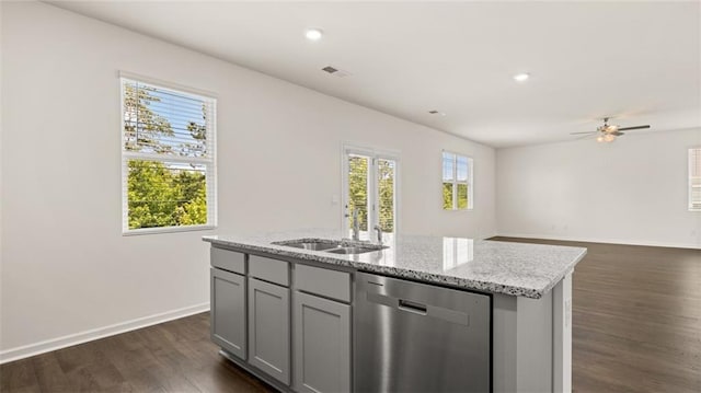 kitchen featuring dishwasher, dark wood-type flooring, a center island with sink, ceiling fan, and gray cabinetry