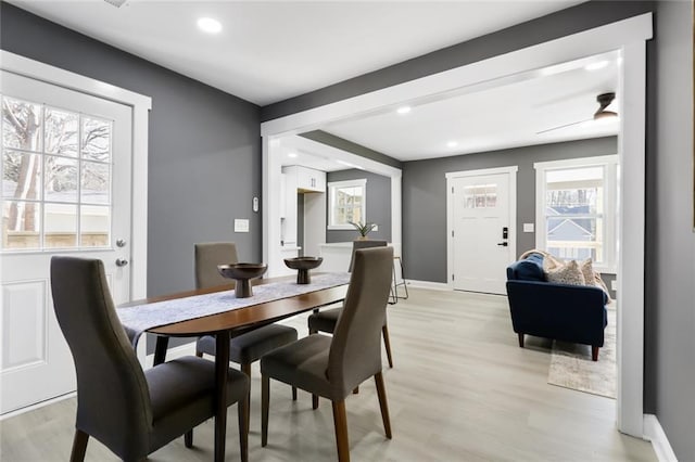 dining space with light wood-type flooring and ceiling fan