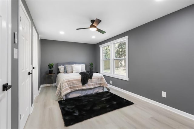 bedroom with light wood-type flooring and ceiling fan