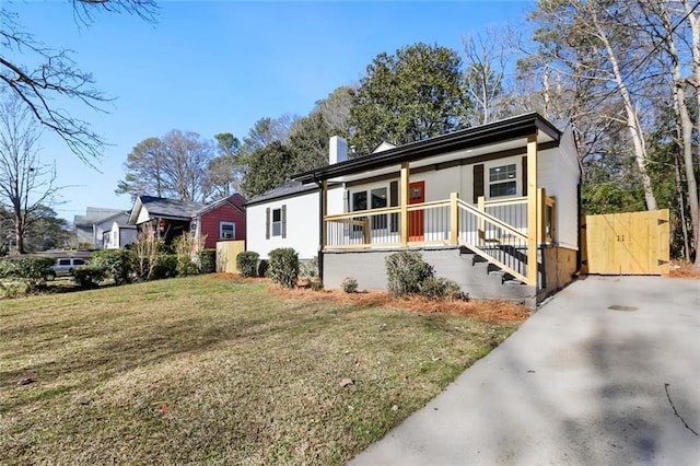 view of front of house with a porch and a front lawn