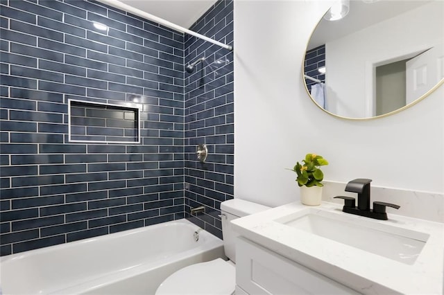 full bathroom with tiled shower / bath, vanity, and toilet