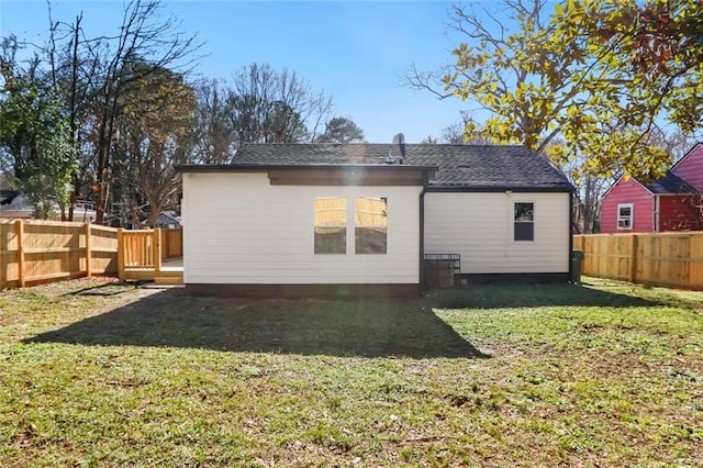 rear view of property featuring a yard