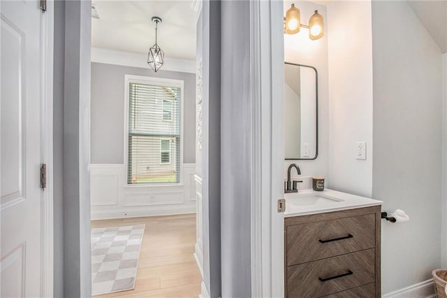 bathroom featuring a wainscoted wall, vanity, and wood finished floors