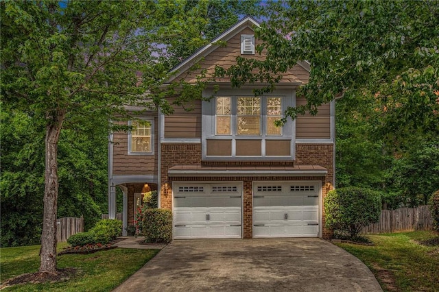 view of front of house with a garage, fence, a front yard, brick siding, and concrete driveway