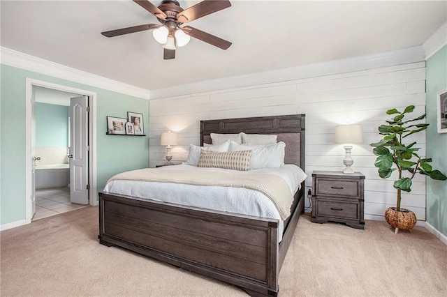 bedroom with baseboards, ornamental molding, carpet flooring, and ensuite bath