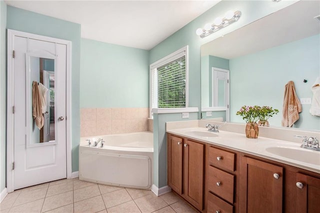 full bath with a bath, double vanity, a sink, and tile patterned flooring