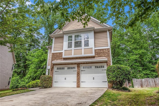view of front of house with a garage, fence, concrete driveway, and brick siding