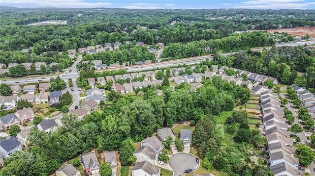 birds eye view of property featuring a residential view and a view of trees
