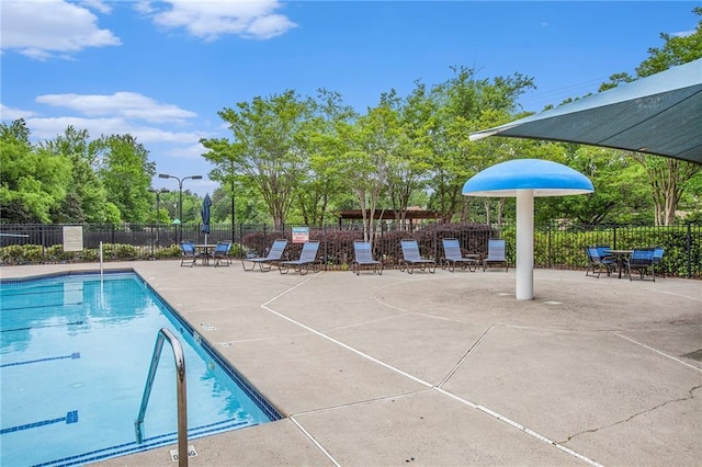 pool featuring a patio and fence